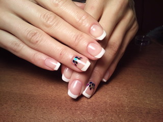 The manicurist excellently made her work a beautiful manicure with a polish gel on her hands and the client is happy