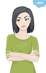 An angry young woman crossed her arms. The girl is standing in a green sweater with her arms crossed over her chest.