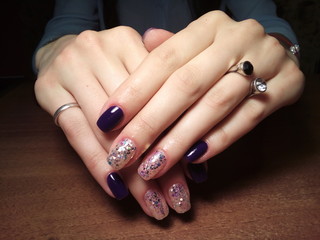 The manicurist excellently made her work a beautiful manicure with a polish gel on her hands and the client is happy