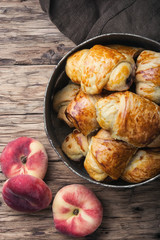 Tasty croissants with peaches