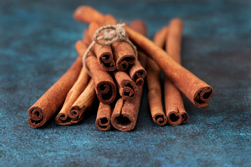 Cinnamon sticks on blue background. Dark