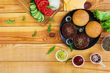Ingredients for burger on wooden background. Top view