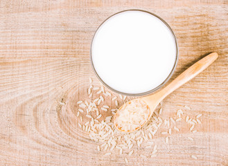 Rice milk on the wooden background .