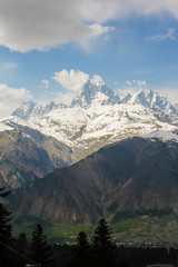 Fototapeta na wymiar Ushba peak and Mestia in the valley