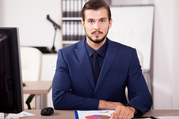 Busy Businessman in suit working in his office. Business and corporate. Image of young succesful entrepreneur at his work place.