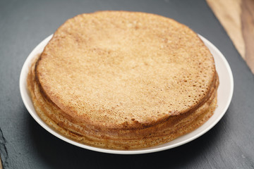 homemade blini stack on plate on slate board