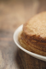 homemade blini stack on plate on wood table
