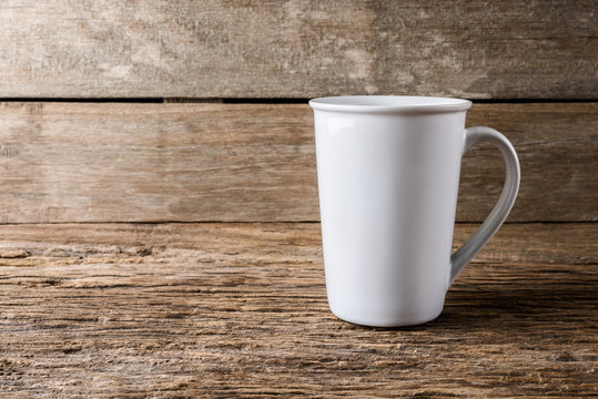 empty white cup on wooden background