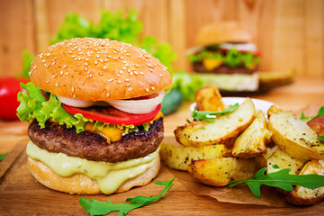 Delicious handmade burger on wooden background. Close view