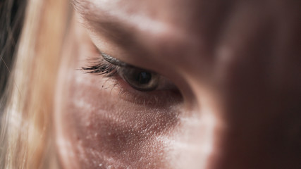 handheld closeup shot of teen girl eyes looking at smartphone screen in sunset light near window