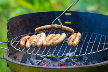 Barbecue sausages are grilled on a barbecue