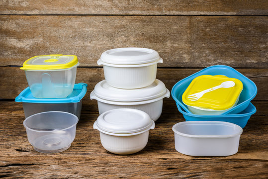 Empty containers for food on wooden background