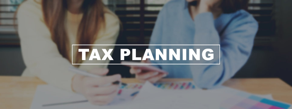 Text Tax planning on background women are working on smartphone. The concept of working with a lot of information.