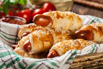 Rolled hot dog sausages baked in puff pastry