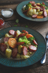Fried vegetables with smoked sausages
