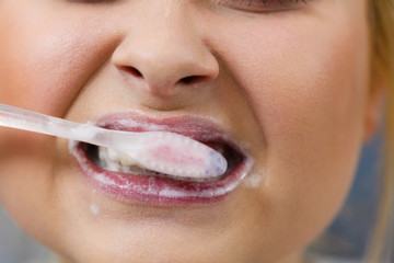 Naklejka premium Woman brushing cleaning teeth