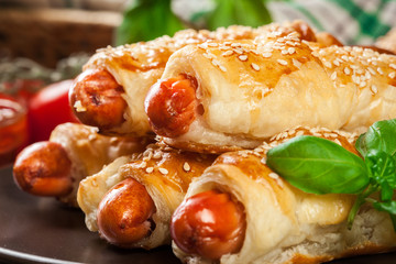 Rolled hot dog sausages baked in puff pastry