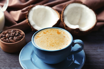 Cup of coconut coffee on blurred background