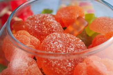 Glass bowl with tasty candies, closeup