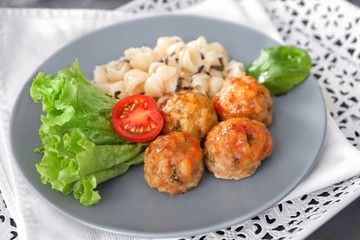 Plate with turkey meatballs and pasta on table, closeup