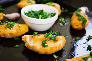 Baked dumplings with dill sauce. Close view