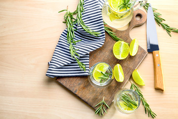 Glasses of fresh lime lemonade with rosemary on table