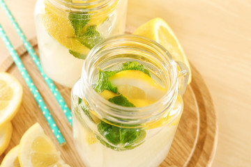 Mason jar of fresh lemonade on table