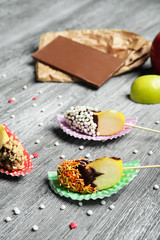 Composition with pieces of candied apple on wooden table