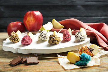 Composition with pieces of candied apple on wooden table