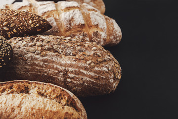 Bakery concept. Plenty of bread background isolated on balck