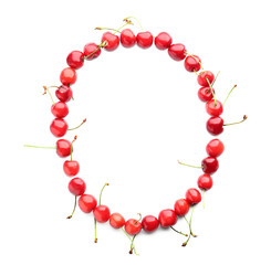 Circle made of fresh cherries on white background