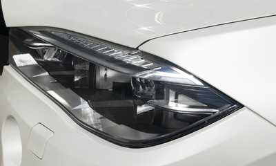 Plakat Headlight of a modern sport car. The front lights of the car. Modern Car exterior details