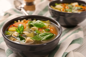Bowl with delicious turkey soup on table