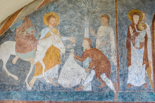 The entry into Jerusalem on palm Sunday, a romanesque wall-painting. Jesus rides on the donkey 