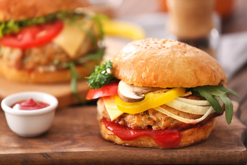 Tasty turkey burger on wooden board