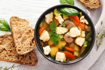 Bowl with delicious turkey soup on napkin