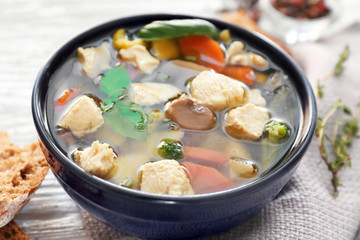 Bowl with delicious turkey soup on napkin