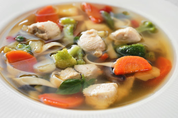Plate with delicious turkey soup, close up