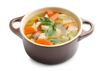 Casserole with delicious turkey soup on white background