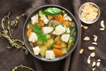 Bowl with delicious turkey soup on napkin