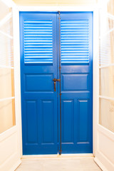 Blue door and window  with shutters