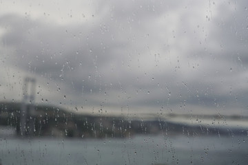 Rain drops on window against bosphorus view of Istanbul, Turkey