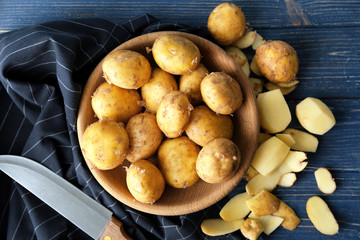 Composition with raw organic potatoes on wooden table