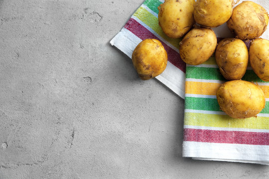 Raw organic potato on grey background