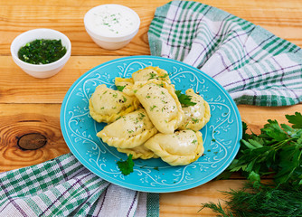 Delicious dumplings with cabbage on wooden background