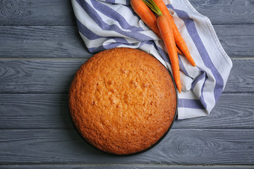 Delicious carrot cake on wooden background