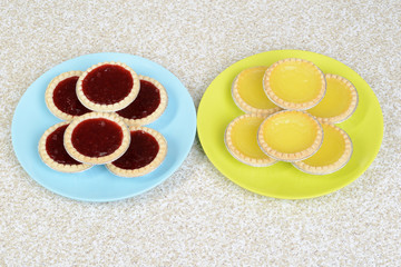 strawberry and lemon tarts on plates