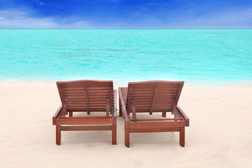 Obraz na płótnie Canvas Sun loungers on beach in summer day