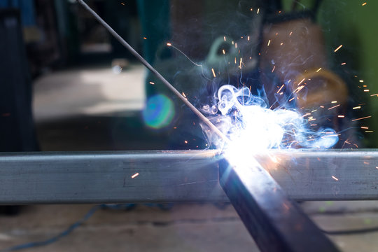 Sparks and smoke welding iron.