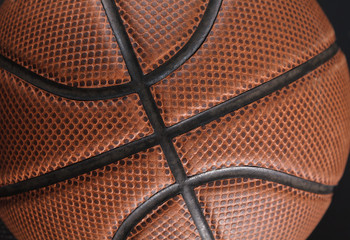 Fototapeta premium Old basketball ball on black background closeup